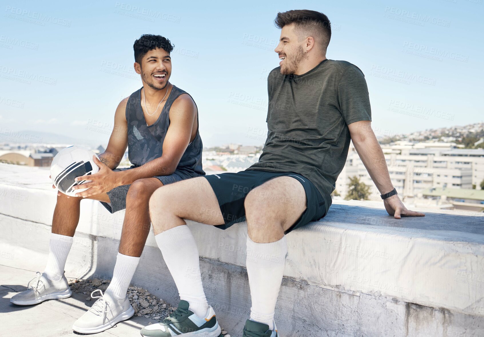 Buy stock photo Friends, sports and talking after soccer game on rooftop for urban sports, exercise and training outdoor in summer. Athlete men have conversation about fitness, football and city lifestyle with ball