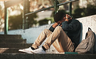 Buy stock photo Student, mental health and depression with anxiety, burnout and sad for exam results, fail or mistake while sitting outdoor. Young man, stress and tired and depressed on university or college campus