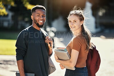 Buy stock photo Students, couple or university friends walking together with books for education and learning on campus with scholarship. Portrait of an interracial man and woman together on college or school ground