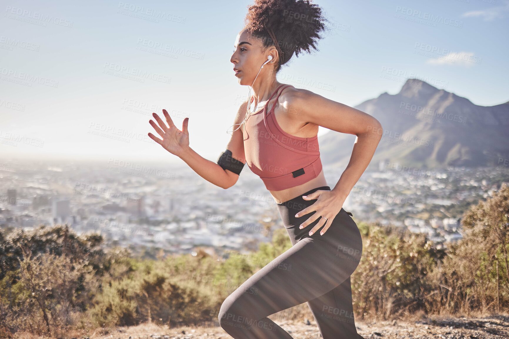 Buy stock photo Music, fitness and woman running along mountain, listening to radio while doing morning cardio, wellness and exercise. Sports, podcast and black woman focused on training, run and workout with energy