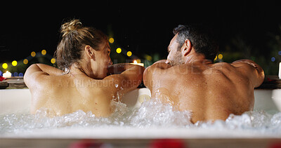 Buy stock photo Couple, night and back with pool for honeymoon vacation or luxury holiday together at resort. Man, woman or lovers enjoying water with hot tub in late evening for romantic date, romance or getaway