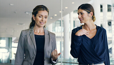 Buy stock photo Business women, attorney and talking in office building for walking, together or discussion in law firm. Female people, colleagues and mentorship as lawyer for teamwork, conversation or collaboration