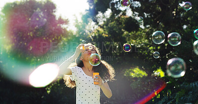 Buy stock photo Child, blowing and bubbles in air outdoor for playful fun, learning activity and sensory stimulation. Girl, active and wand with soap for games, fine motor skills and creative imagination in backyard