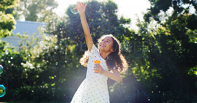 Buy stock photo Happy, kid and blowing bubbles outdoor for playful fun, learning activity and sensory stimulation. Excited, girl and soap in air of catch games, fine motor skills and creative imagination in backyard