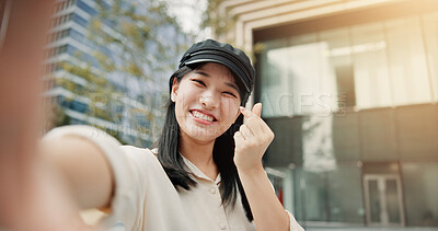 Buy stock photo Asian woman, portrait and selfie with finger heart in city for picture, photography or memory. Japan, female person or tourist with smile, love emoji or Kpop culture for capture moment in urban town