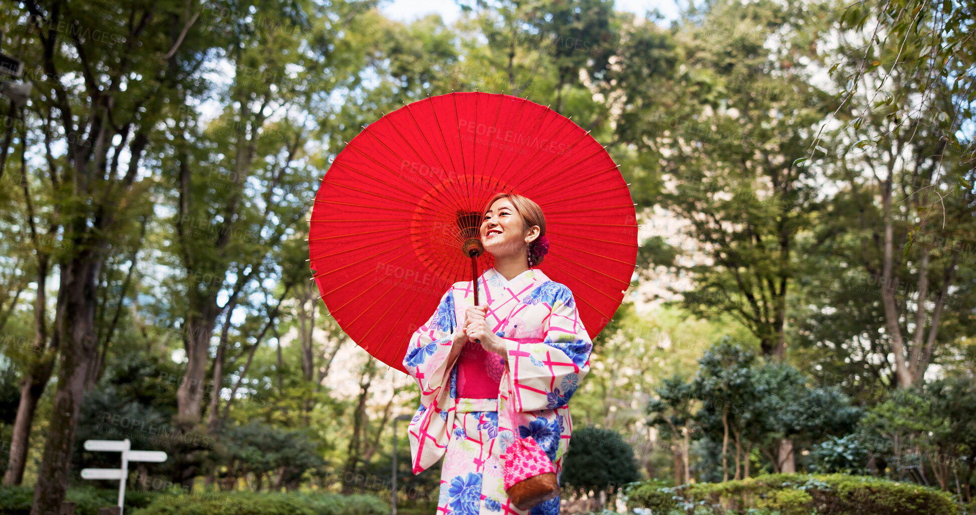 Buy stock photo Park, umbrella and Japanese woman with fashion, sightseeing and urban travel with trees. Path, kimono and parasol with walking, outdoor and journey with smile, style and traditional Asian dress