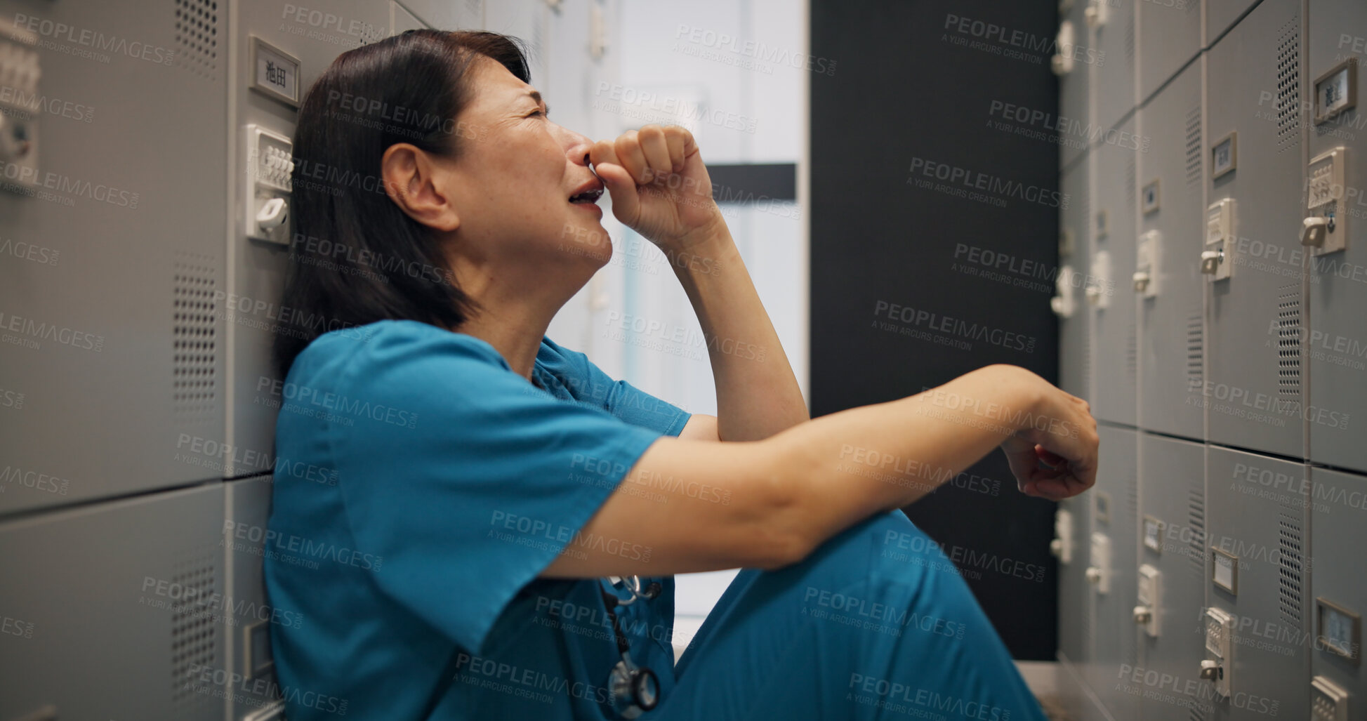 Buy stock photo Doctor, crying and japanese woman with depression, fear and burnout from surgery in locker room. Hospital, professional and bad news with fatigue, mental health and overwhelmed from medical crisis