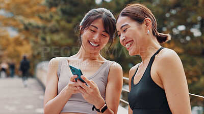 Buy stock photo Japan, exercise and women with cellphone, fitness and typing with funny meme. Laughing, outdoor and runners with smartphone, happiness and tech for online reading, digital app and workout with humor