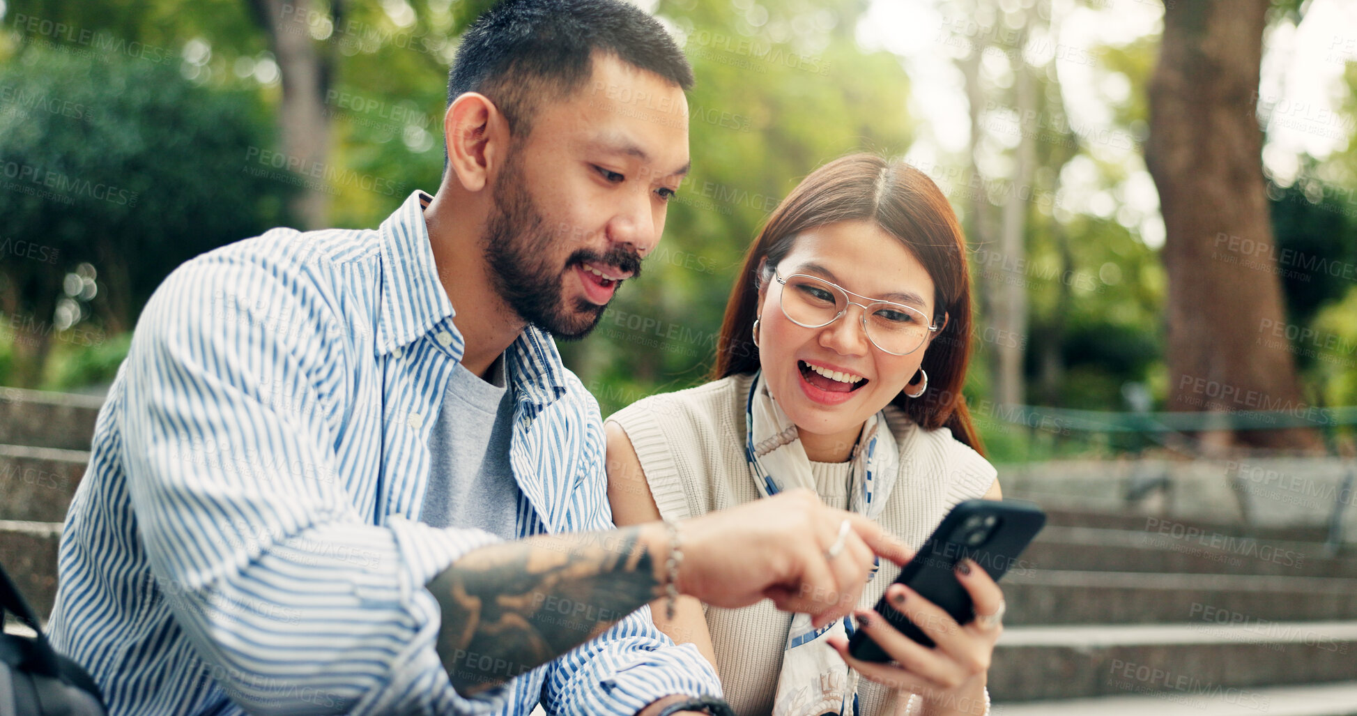 Buy stock photo Couple, smartphone and happy on travel at park on stairs, click and excited for discount on hotel booking. People, man and woman with phone, mobile app and notification on social network in Japan