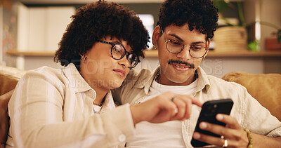 Buy stock photo Relax, pointing and phone with couple on sofa for streaming, bonding or social media post. Networking app, connection and share link with man and woman in living room of home for subscription service
