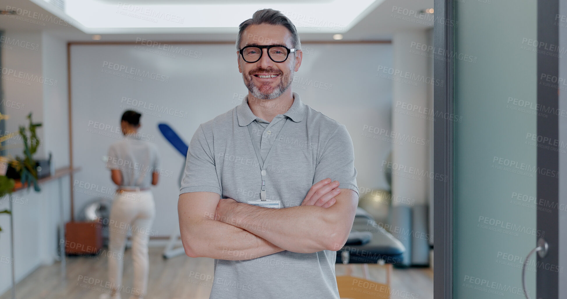 Buy stock photo Portrait, happy man and confidence as physiotherapist in gym, rehabilitation clinic or wellness practice. Male person, pride and arms crossed with smile, personal trainer or coach for physio exercise