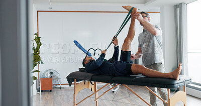 Buy stock photo Physical therapy, men and band for stretching legs at clinic, helping and recovery on table. People, flexibility training and chiropractor for rehabilitation treatment, support and healing service