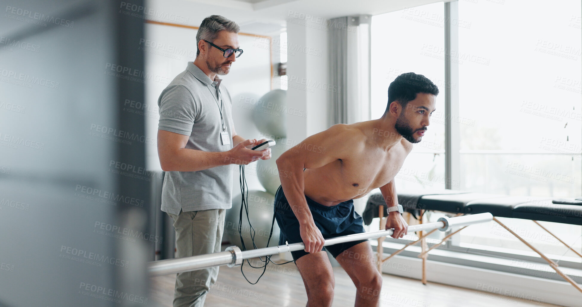 Buy stock photo Physiotherapy, consulting and tracking with man in clinic for biofeedback, muscle stimulation and monitor progress. Rehabilitation, healthcare and training with people for fitness, help and healing