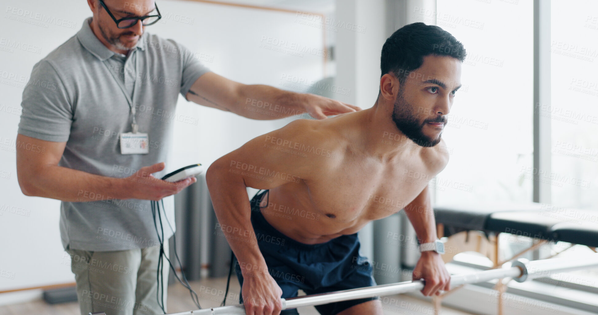 Buy stock photo Physiotherapy, consulting and monitor with man in clinic for biofeedback, muscle stimulation and track progress. Rehabilitation, healthcare and training with people for chiropractor, help and healing