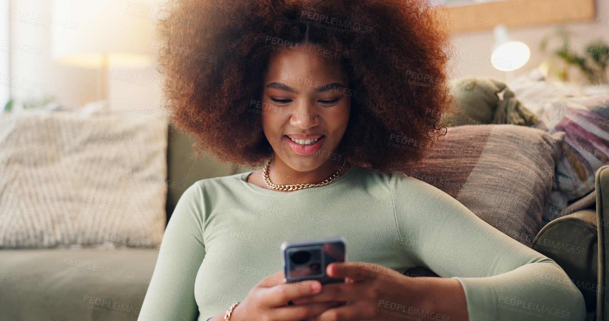 Buy stock photo Smile, mobile and woman in home to relax, texting or check social media blog post online. Phone, happy and African girl in living room for communication, reading news or download chat app on internet