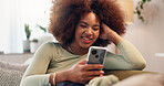 Smile, mobile and woman on sofa to relax, streaming show or check social media blog post online. Phone, happy and African girl in home for communication, reading news or download chat app on internet