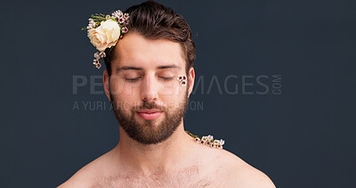 Buy stock photo Relax, skincare and man in studio with flowers, confidence and natural self care in creative aesthetic. Nature, floral and male person with organic cosmetics, dermatology and pride on grey background