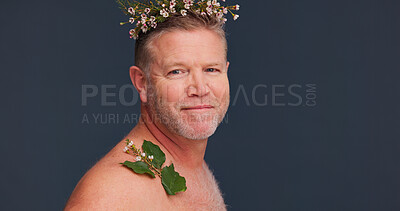 Buy stock photo Beauty, flower crown and portrait of gay man in studio on dark background for natural skincare. Cosmetics, dermatology and happy with mature queer person in floral wreath for antiaging wellness