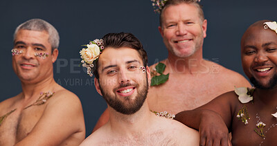 Buy stock photo Beauty, portrait and men with flowers in studio for cosmetics, wellness and skincare. Queer, lgbtq diversity and people with plants for natural skin, self confidence or aesthetic on blue background