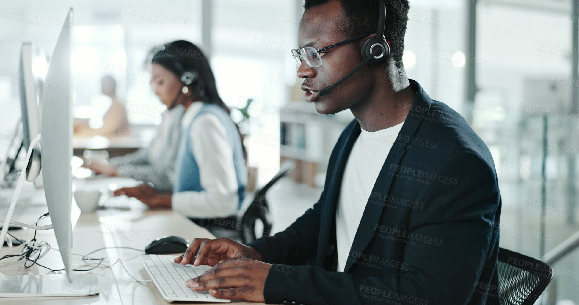 Buy stock photo Call center, consulting and typing with black man in support office for customer service. Computer, contact us and feedback with person speaking on headset in workplace for virtual help or research