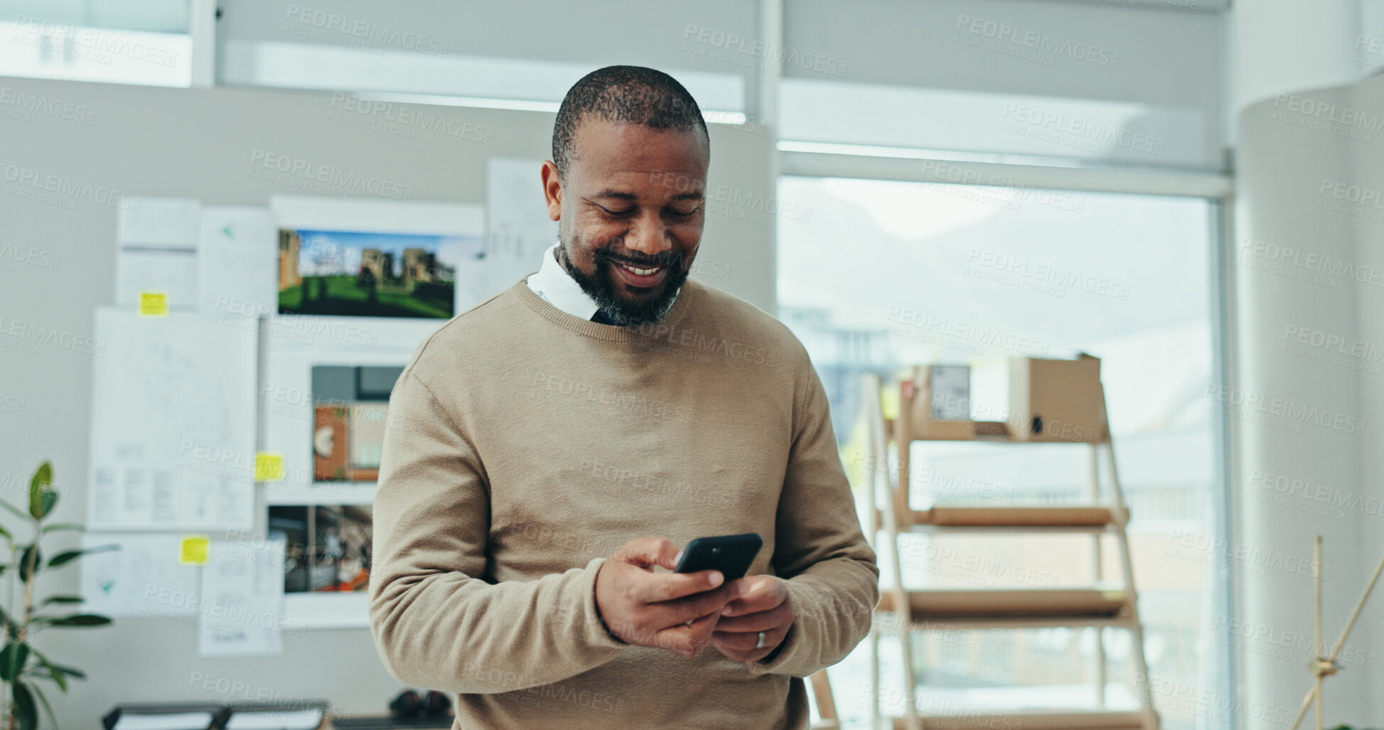 Buy stock photo African man, phone and happy at startup with notification, sale and deal with artwork in studio. Person, dealer and smartphone for email, contact and smile with app for networking at creative agency