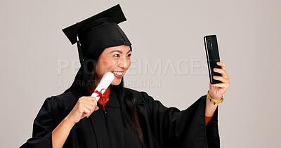 Buy stock photo Woman, university graduation and happy with selfie and scroll for memories, profile picture and social media. Asian person, studio background and smile for certificate with celebration of achievement