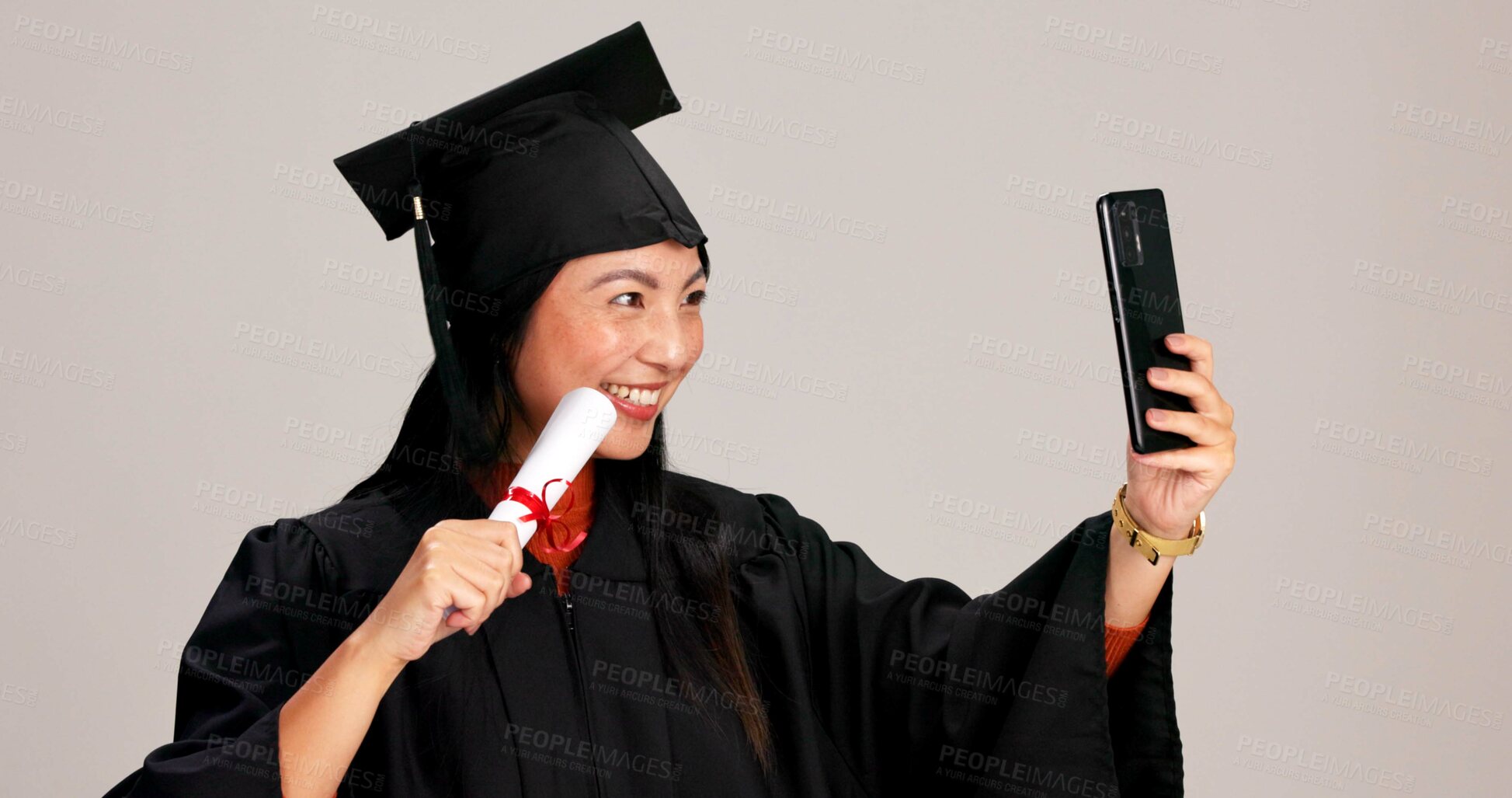 Buy stock photo Woman, university graduation and happy with selfie and scroll for memories, profile picture and social media. Asian person, studio background and smile for certificate with celebration of achievement