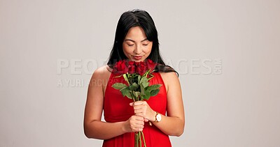 Buy stock photo Woman, studio background and smelling roses for love, care and valentines day celebration in Japan. Japanese person, romance and eyes closed in red dress with bouquet of flower as anniversary gift