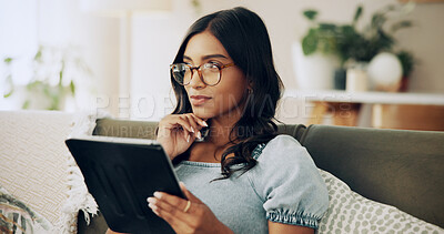 Buy stock photo Woman, tablet and thinking on sofa with social media, connectivity or travel planning in home. Girl, student or tech in living room on study break, blog update or idea for creative writing assignment