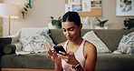 Phone, fitness and woman on internet in home for health tips, scroll message and reading sports blog. Mobile, relax and Indian girl in living room for chat app, communication and check social media