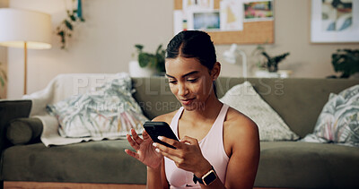 Buy stock photo Phone, fitness and woman on internet in home for health tips, scroll message and reading sports blog. Mobile, relax and Indian girl in living room for chat app, communication and check social media