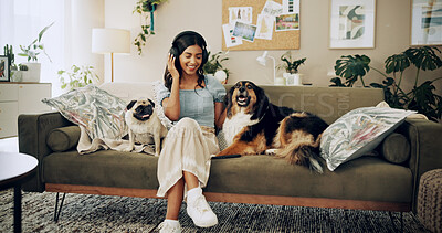 Buy stock photo Happy woman, home and dogs with headphones, music listening and bonding for love, companion and play. Female person, technology and pets for emotional support, happiness and streaming in living room