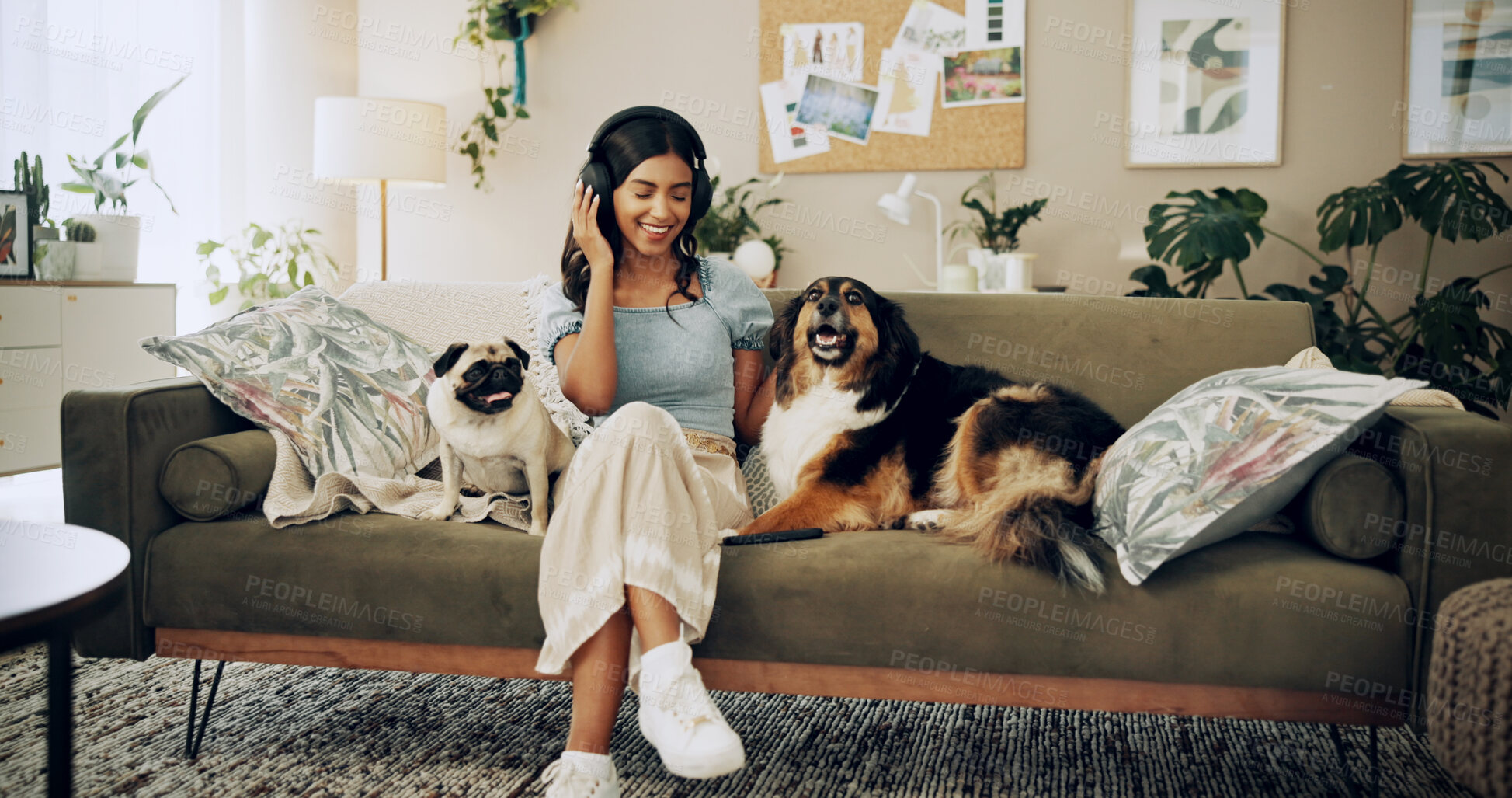 Buy stock photo Happy woman, home and dogs with headphones, music listening and bonding for love, companion and play. Female person, technology and pets for emotional support, happiness and streaming in living room