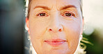 Closeup, confidence and portrait of mature woman in nature for health, retirement or wellness. Calm, peace and serious with face of senior person outdoor in France for concentration or pride