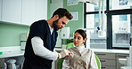 Dentist, teeth mold and man with woman in clinic for cleaning demonstration, dental hygiene and gum wellness. Healthcare, dentistry and patient with model for consulting, oral care or medical service