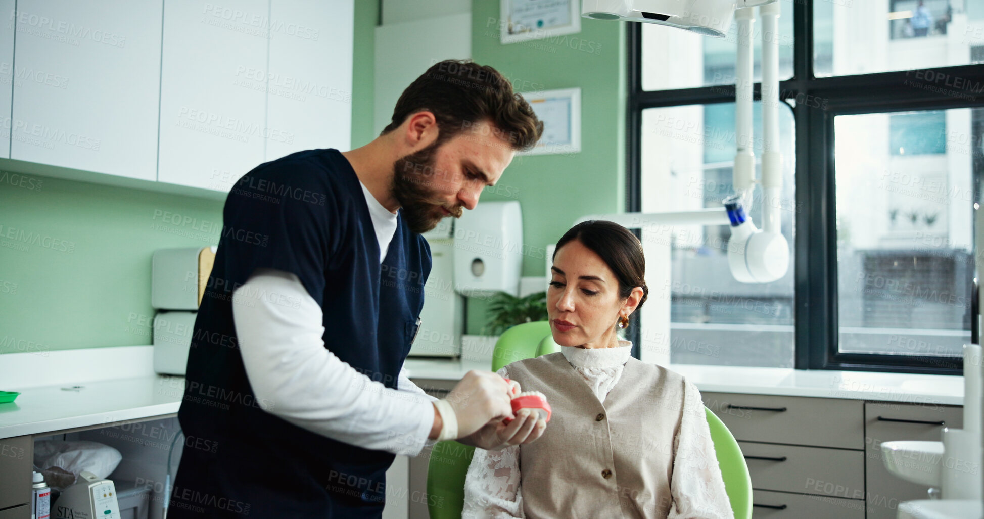 Buy stock photo Dentist, teeth mold and man with woman in clinic for cleaning demonstration, dental hygiene and gum wellness. Healthcare, dentistry and patient with model for consulting, oral care or medical service