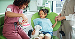 Dentist, tooth model and woman with child in clinic for extraction, cleaning and wellness. Healthcare, dentistry and girl with hygienist explain for dental hygiene, oral care and medical services