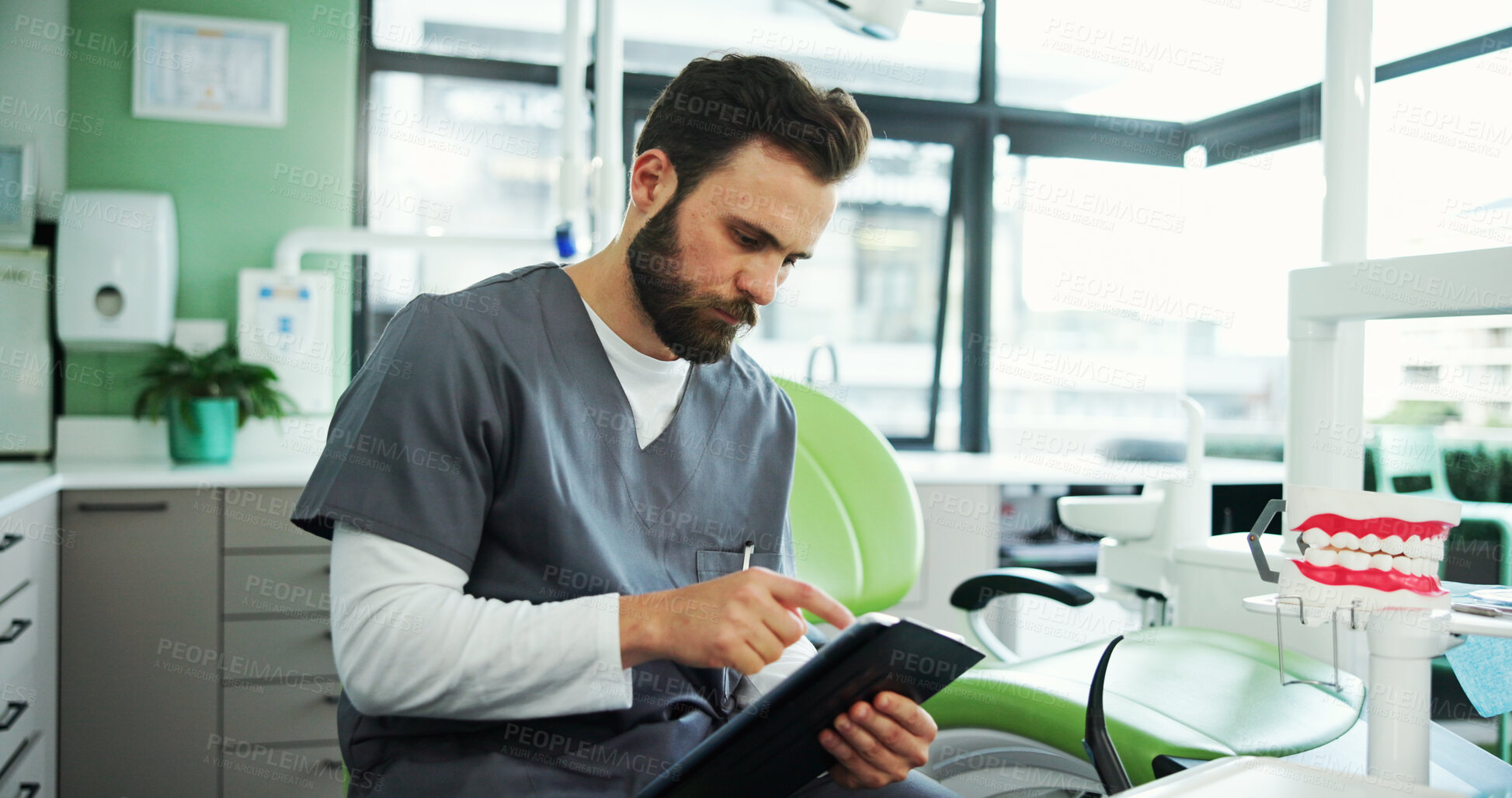 Buy stock photo Clinic, office and dentist with tablet for medical service, appointment schedule and research. Healthcare, hospital and man on digital tech with results for consultation, oral care and dental hygiene