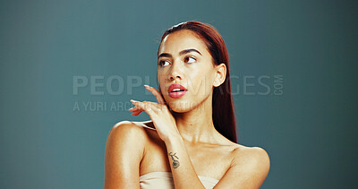 Buy stock photo Beauty, skincare and woman in studio thinking for wellness, health and facial treatment. Dermatology, spa and isolated person with cosmetics for natural texture, salon and shine on blue background