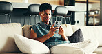 House, relax and man on sofa, smartphone and typing with social media, connection and network. Apartment, person and guy on couch, cellphone and message to contact, digital app and texting in lounge