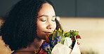 Happy woman, flowers and aroma in home as gift for anniversary, birthday or celebration as romantic. Female person, bouquet and smelling with joy, smile and love as gesture, present or valentines day