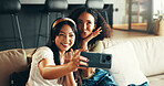 Women, friends and happy in home for selfie, weekend visit and making memories for social media. People, reunion and excited in living room with photography, heart fingers and connectivity for update
