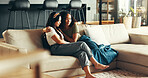 House, comfort and women on sofa, hug and sad with emotion, support and relax. People, apartment and friends on couch, embrace and reaction with compassion, empathy and sympathy in living room