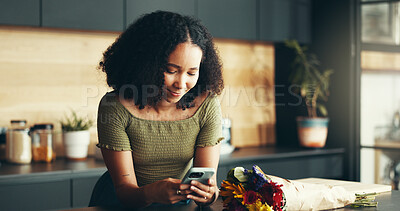 Buy stock photo House, flowers and woman in kitchen, smartphone and internet with social media, texting and smile. Apartment, person and girl with bouquet, cellphone and message to contact, admirer and romantic gift