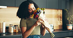 Happy woman, flowers and aroma as romantic gift or gesture for anniversary, birthday or celebration. Female person, bouquet and smelling with joy, smile and love in home as present for valentines day