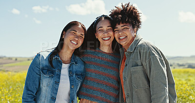 Buy stock photo Women, friends and hug portrait with field for summer adventure, flowers and nature in countryside. Girl group, park and bonding for holiday, social networking and blue sky for sunshine or spring
