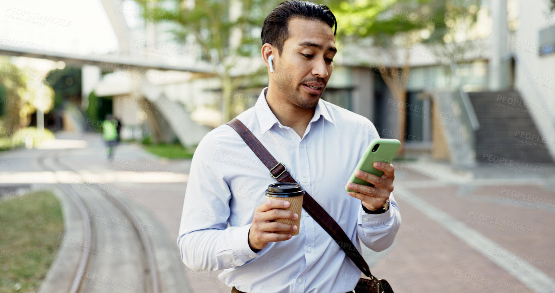 Buy stock photo Businessman, walking and earphones with phone or coffee in city for conversation, discussion or chat. Man, employee or mobile smartphone with drink for communication, online app or texting in town