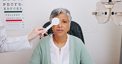 Buy stock photo Doctor, optometry and portrait of woman in test for eye care, hands and mature person with occluder in clinic for health. Ophthalmologist, face and patient with tools for vision check, cover or exam