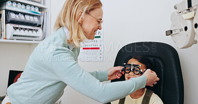 Buy stock photo Trial glasses, doctor or child in eye test at optometry clinic for eyewear, retina health or sight wellness. Check, client or kid in assessment for optical lenses, vision exam or spectacles frames