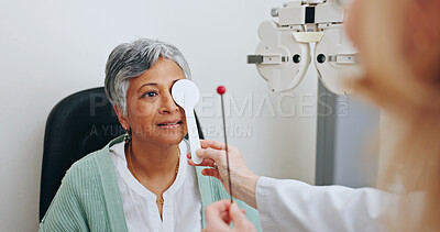 Buy stock photo Doctor, optometry and woman in exam for vision, hands and senior person with occluder or fixation stick in clinic. Ophthalmologist, test and patient with tools for health, cover and eye alignment